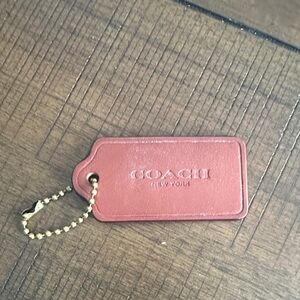 Coach orange/brown/ red in color Leather Bag Tag with Gold Chain